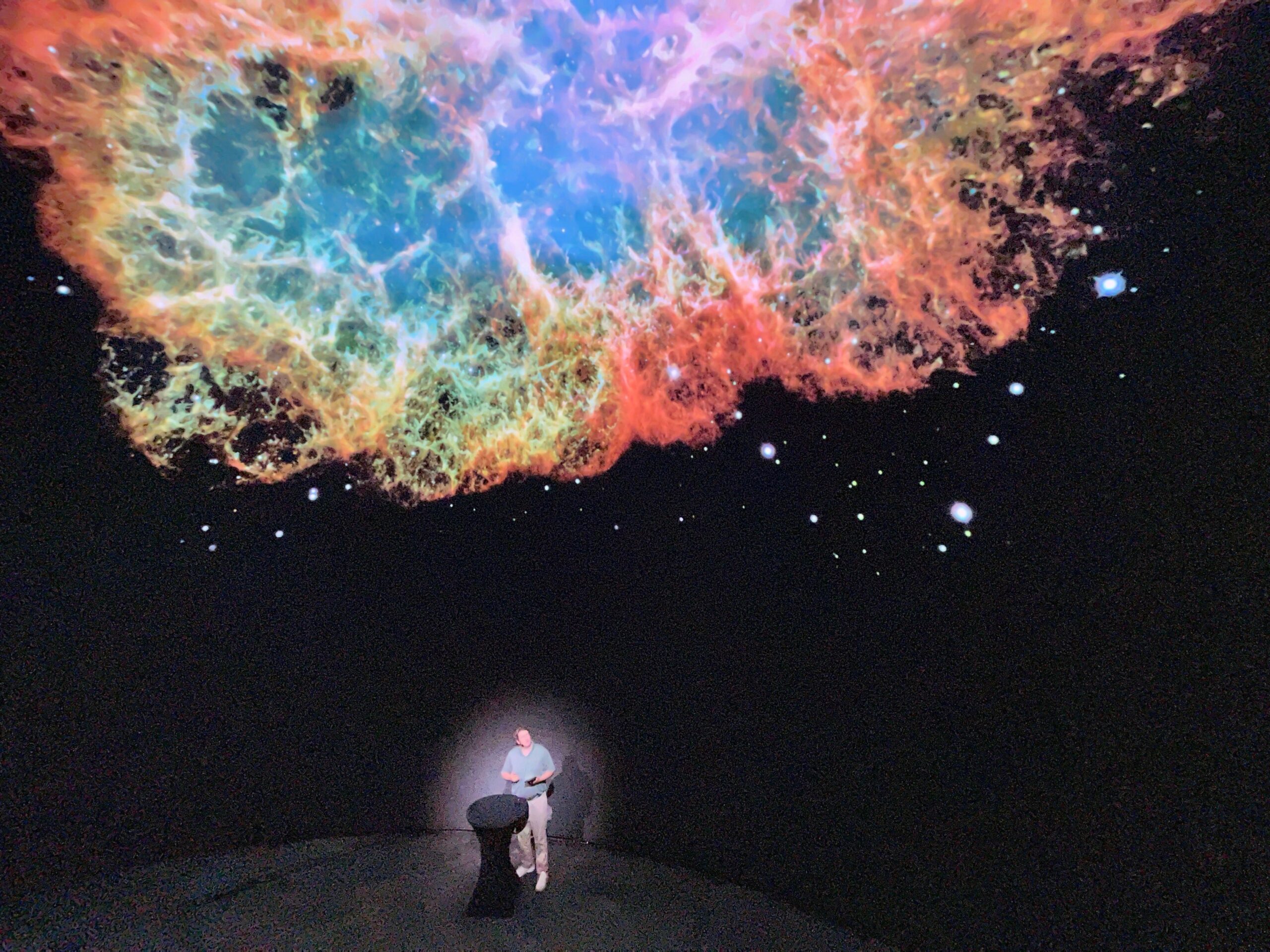 Ian McLennan in front of the LED dome at the Cosm Experience Center. Image courtesy Derek Threinen.